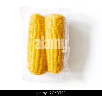 Packaged and sealed yellow corn ears for grocery store; isolated on white background, top view Stock Photo