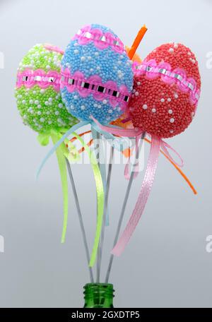 On the eve of Easter, a festive decoration in the form of colorful decorative Easter eggs on sticks. Stock Photo