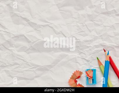 Pencils and sharpener on blank paper Stock Photo
