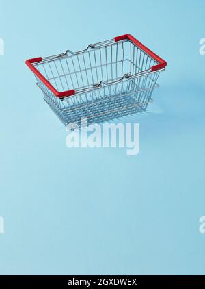 Empty shopping basket on blue background Stock Photo