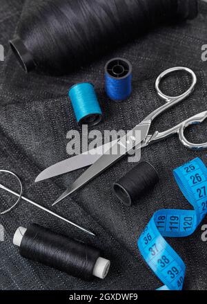 Tailoring thread, scissors, needles, textile and tape measure Stock Photo