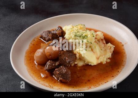 Greek beef stifado. Stew with beef, onion bulbs, cinnamon and spices Stock Photo