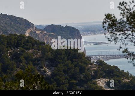 View from the mountain of The city of Castelldefels and Garraf port, Barcelona, Catalonia, Spain in a cloudy spring day Stock Photo