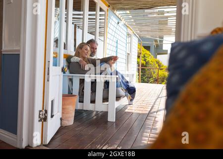 Happy caucasian couple sitting on the sunny terrace Stock Photo