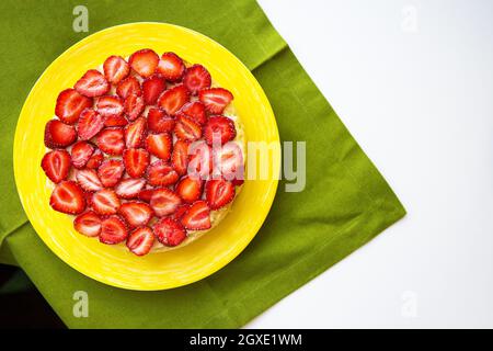 Beautiful strawberry cake is on the table, green napkin. Stock Photo