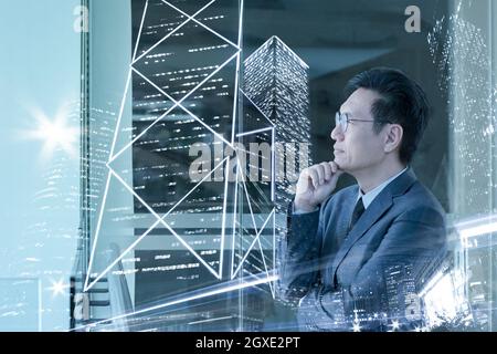 Double exposure of asian businessman and city with high rise skyscrapers. Stock Photo