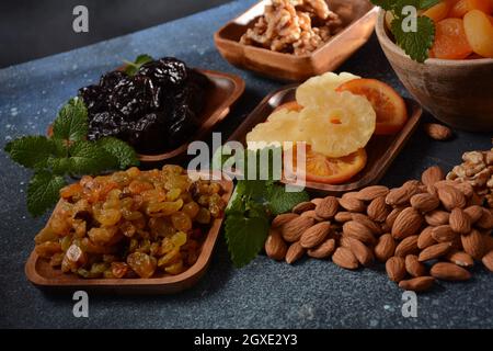 Mix of dried and sun-dried fruits,  in a wooden trays . View from above. Symbols of the Jewish holiday of Tu BiShvat Stock Photo