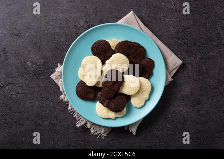 Chocolate Mexican skulls in plate on black stone background Stock Photo