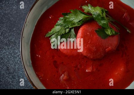 Hot red beet Kubbeh soup, a famous middle eastern dumplings soup dish, served in a bowl. A Jewish-Iraqi traditional matfuniya winter soup. Levantine d Stock Photo