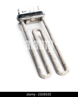 Old washing machine heater with limescale isolated on white background. Stock Photo