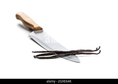 Vanilla pods on knife. Sticks of vanilla isolated on white background. Stock Photo