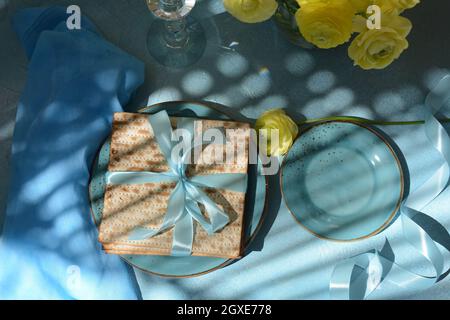 Table served for Passover (Pesach) indoors, with matzah bread as symbolic Pesach (Passover Seder) item. Stock Photo