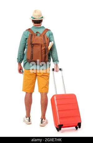 Man from behind with suitcase and backpack Stock Photo