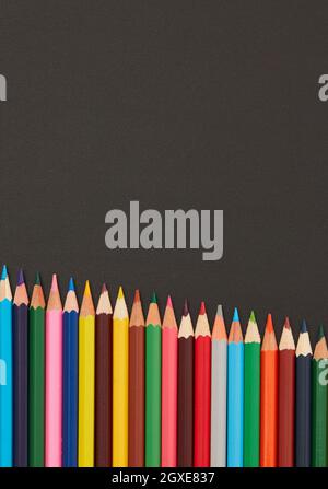 Multi-colored pencils on black background Stock Photo