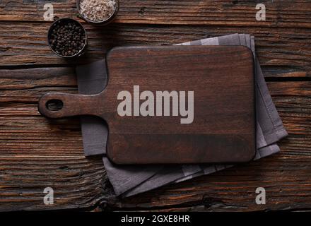 Wooden cutting board on wooden table Stock Photo