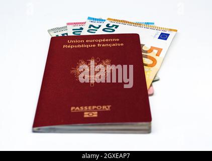 French travel passport with some euro banknotes isolated on a white background. European Union and single currency. Travel and cash Stock Photo