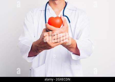 Close up Man doctor with stethoscope he is holding red heart on hand isolate on white background Stock Photo