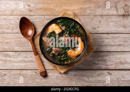 Beef, okra stew and spinach soup in bowl on wooden table Stock Photo