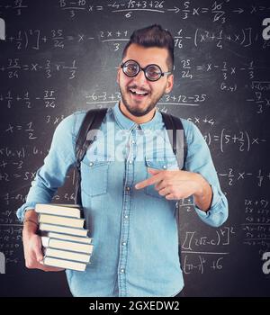 Nerd boy studying in classroom for math Stock Photo