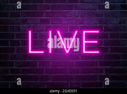 Live neon sign on brick wall Stock Photo