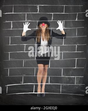 Businesswoman plays to mime imagining a wall Stock Photo