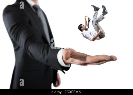 Falling businessman is saved from a big hand. Concept of business support and assistance Stock Photo
