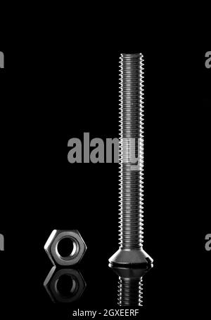 Metal bolt and nut on black background Stock Photo