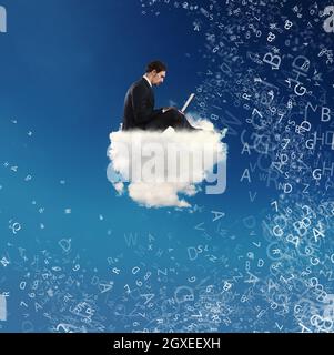 Businessman connected with his laptop over a cloud in the sky. concept of social network and internet addiction Stock Photo