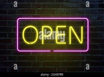 Open neon sign on brick wall Stock Photo
