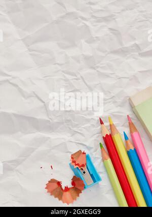 Pencils and sharpener on blank paper Stock Photo
