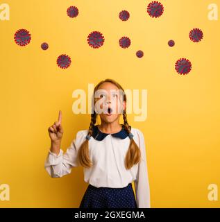 Young student is with shocked expression and indicates codiv-19 virus Stock Photo