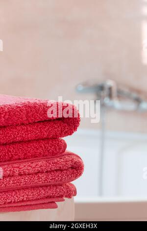 Folded pink towels in bathroom Stock Photo