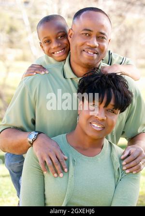Attractive African American Man, Woman and Child posing in the park. Stock Photo
