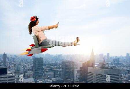 Woman drives fast with rockets under the chair. Stock Photo