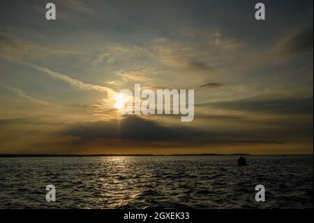 September sun setting over the North Sea coast in Norfolk, England, viewed from Blakeney Point. Stock Photo
