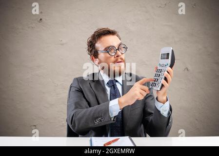 Nerd accountant does complex calculation of company revenue Stock Photo