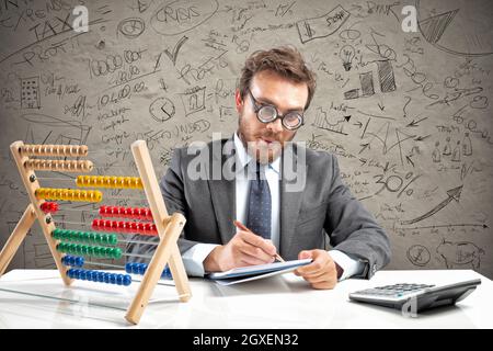 Nerd accountant does complex calculation of company revenue Stock Photo