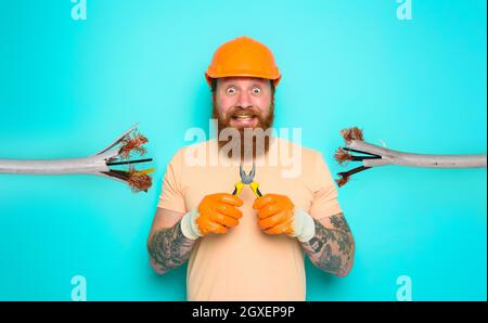 Incompetent worker electrician is unsure about his work Stock Photo