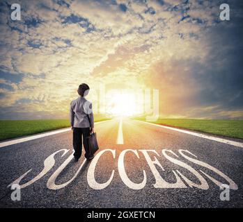 Young man walks on a big success way. Concept of successful businessman and company startup Stock Photo