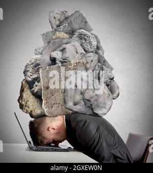 Concept of Stress at work with rocks above the head Stock Photo