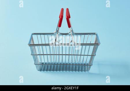 Empty shopping basket on blue background Stock Photo