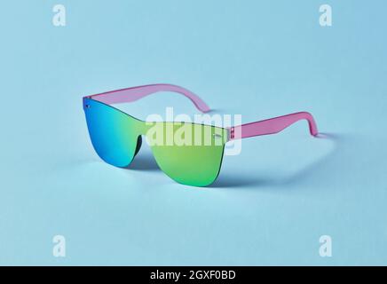 Summer multi-colored sunglasses on blue background Stock Photo