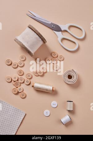 Materials and accessories for sewing - fabric, pins, thread, buttons, top view Stock Photo