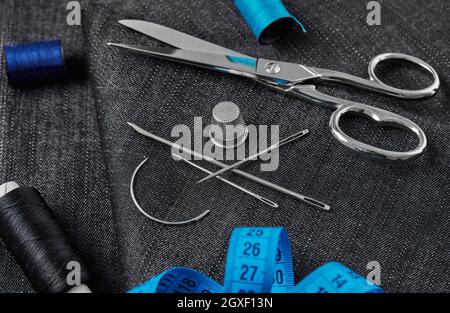 Tailoring thread, scissors, needles, textile and tape measure Stock Photo