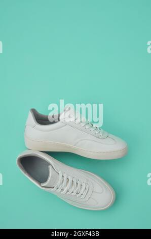 White classic shoes on green background Stock Photo