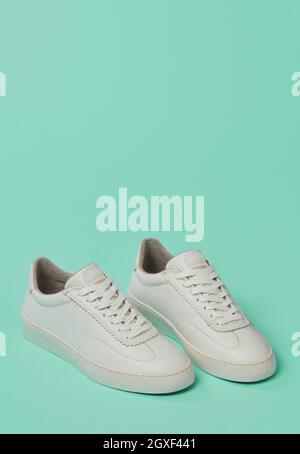 White classic shoes on green background Stock Photo