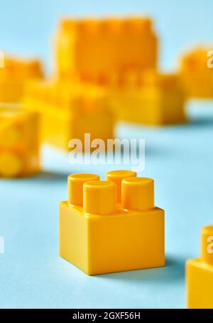 Plastic toy blocks on blue background Stock Photo