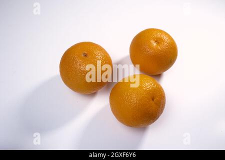 Three oranges on white isolated background Stock Photo
