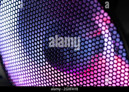 Detail of the case of a gaming pc with fan illuminated by rgb led and protection net Stock Photo