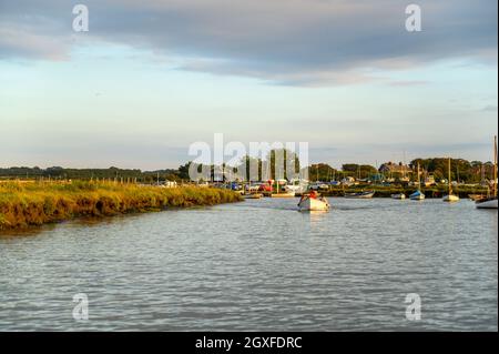 Young family in a small, open leisure boat driving out from Morston Quay in low evening sunshine, Norfolk, England. Stock Photo